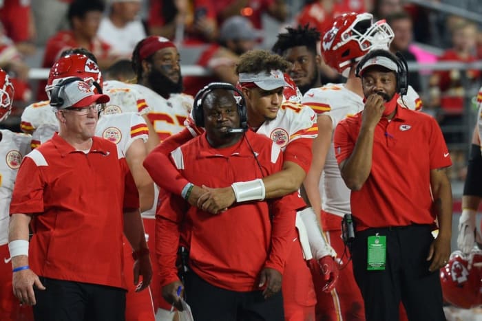 Kansas City Chiefs quarterback Patrick Mahomes (15) hugs offensive coordinator Eric Bieniemy